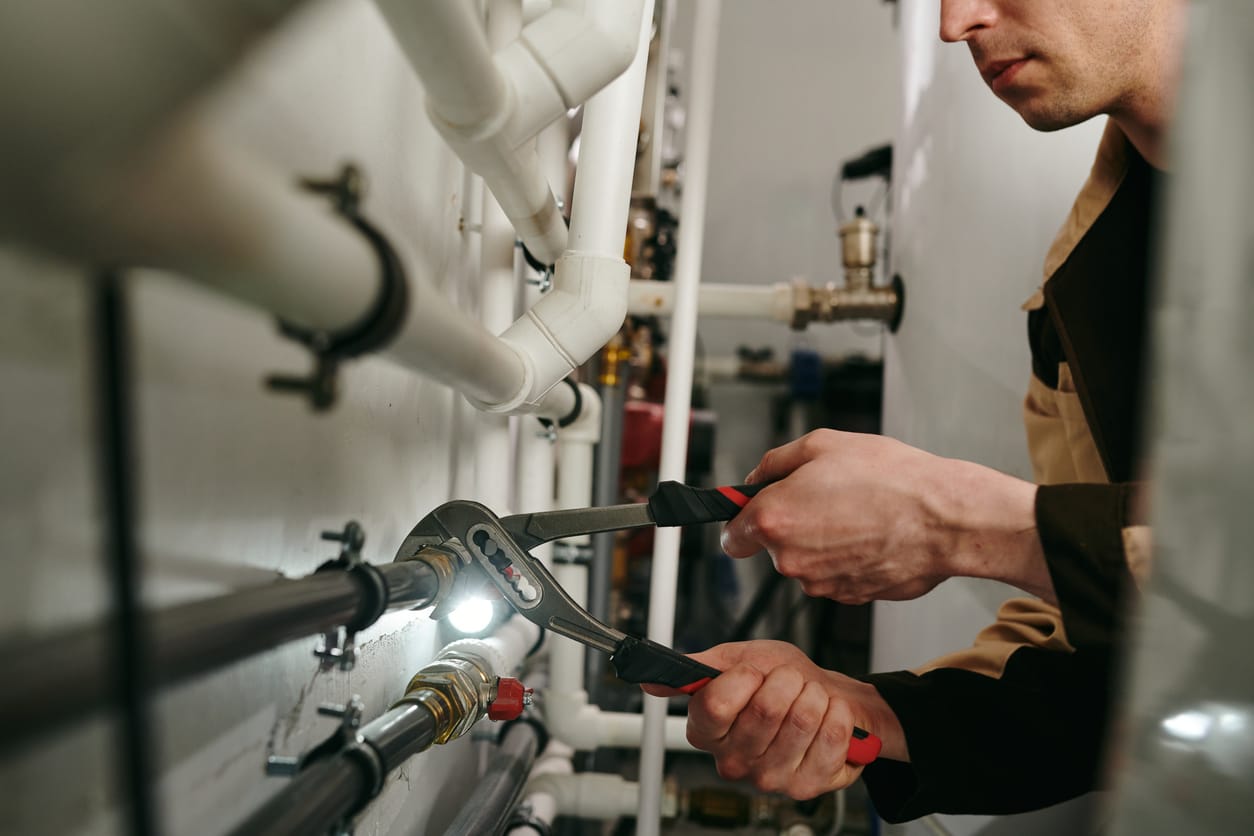 Plumbers maintaining commercial plumbing pipes in Apollo Beach