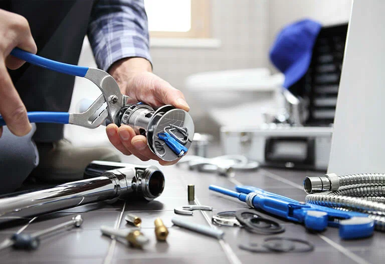 Technician repairing a plumbing fixture with professional tools in Apollo Beach