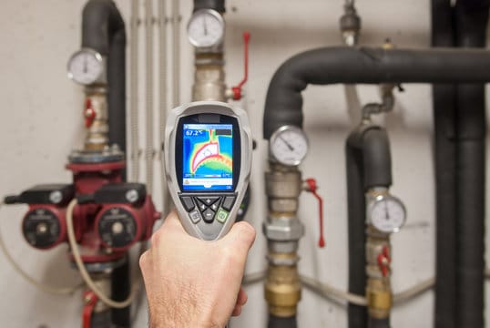 Plumber using a thermal imaging camera to inspect pipes in Apollo Beach