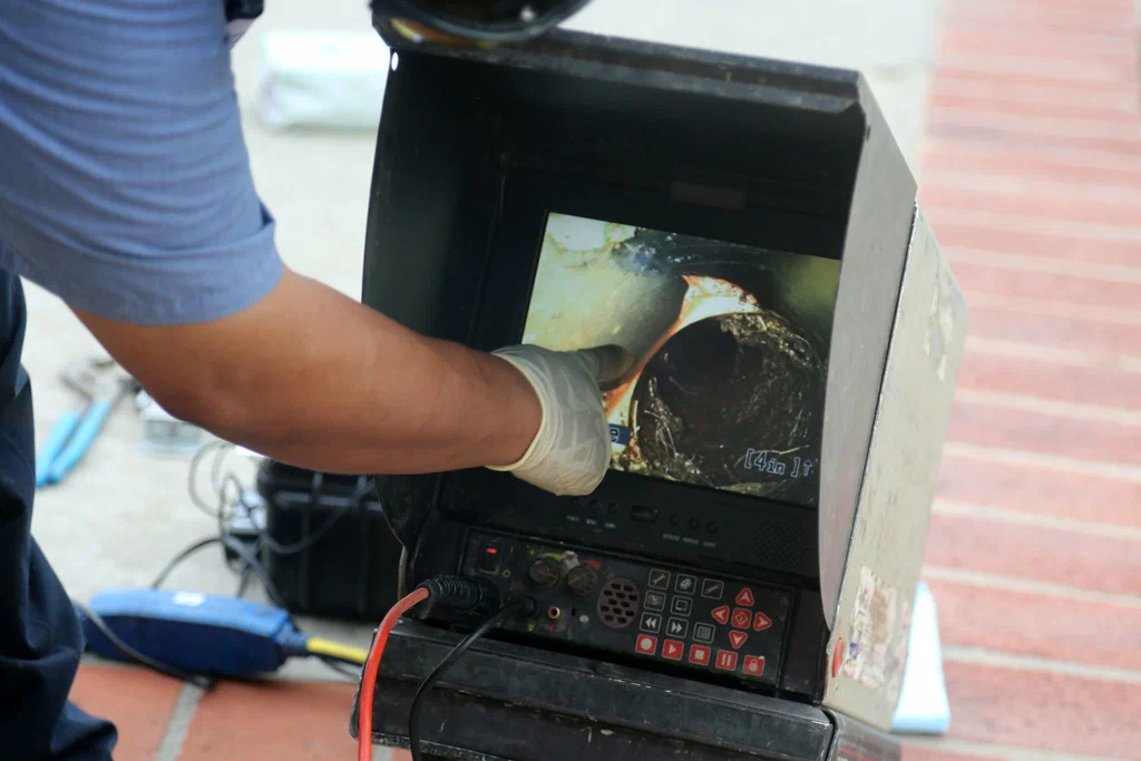 Technician viewing a drain inspection camera in Apollo Beach
