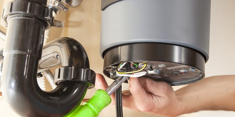 Technician repairing the heating element of a water heater in Apollo Beach