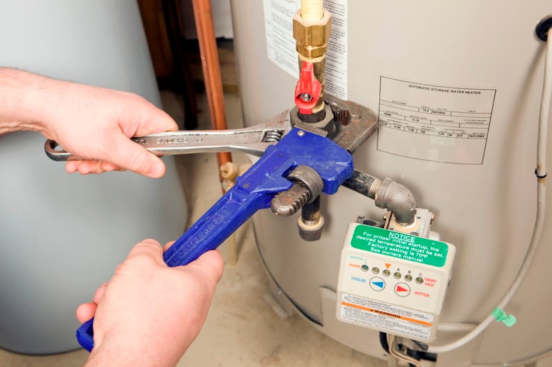 Plumber repairing a water heater valve in Apollo Beach
